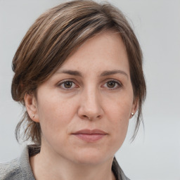 Joyful white adult female with medium  brown hair and grey eyes