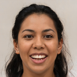 Joyful white young-adult female with long  brown hair and brown eyes