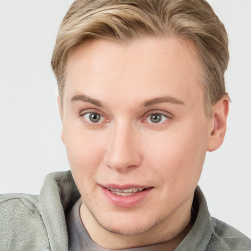 Joyful white young-adult female with short  brown hair and blue eyes