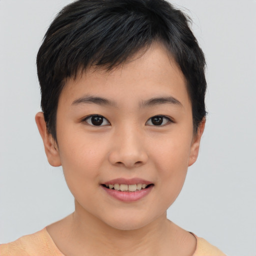 Joyful asian child female with short  brown hair and brown eyes