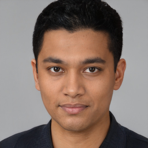 Joyful latino young-adult male with short  black hair and brown eyes