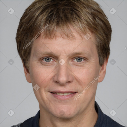 Joyful white adult male with short  brown hair and grey eyes