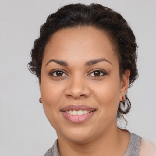 Joyful latino young-adult female with short  brown hair and brown eyes