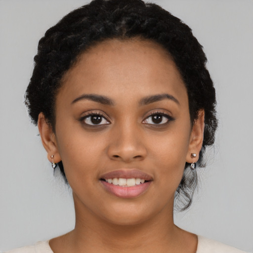 Joyful latino young-adult female with short  black hair and brown eyes