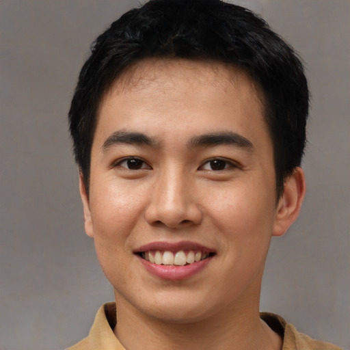 Joyful asian young-adult male with short  black hair and brown eyes