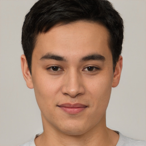 Joyful asian young-adult male with short  brown hair and brown eyes