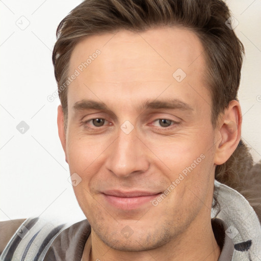 Joyful white adult male with short  brown hair and brown eyes