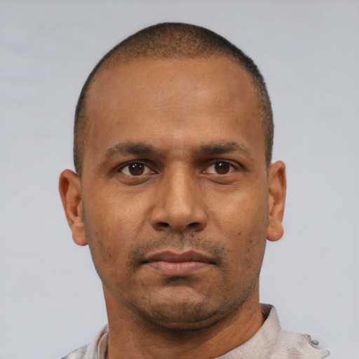 Neutral latino adult male with short  brown hair and brown eyes