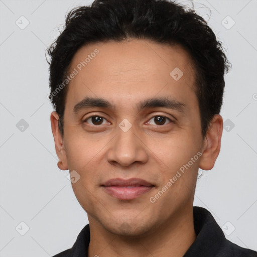 Joyful latino young-adult male with short  black hair and brown eyes