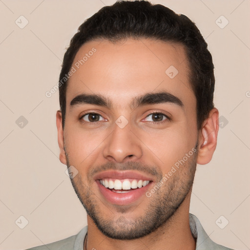 Joyful white young-adult male with short  black hair and brown eyes