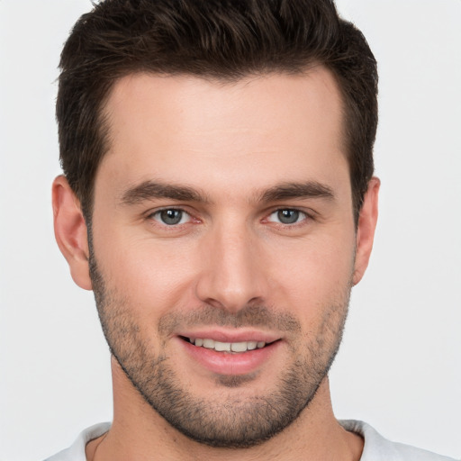 Joyful white young-adult male with short  brown hair and brown eyes