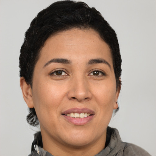 Joyful white young-adult female with short  black hair and brown eyes