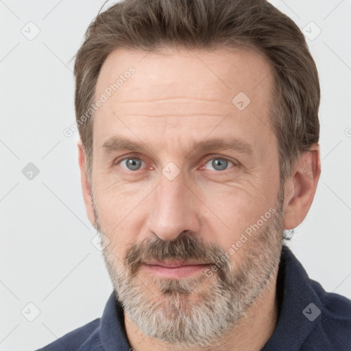 Joyful white adult male with short  brown hair and grey eyes