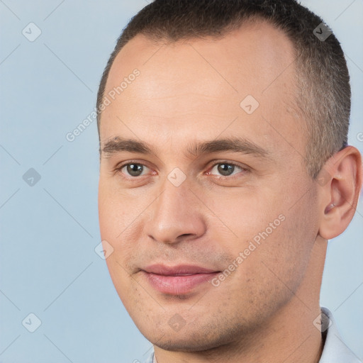 Joyful white young-adult male with short  brown hair and brown eyes