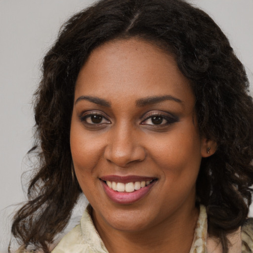 Joyful black young-adult female with medium  brown hair and brown eyes