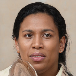 Joyful latino adult female with medium  brown hair and brown eyes