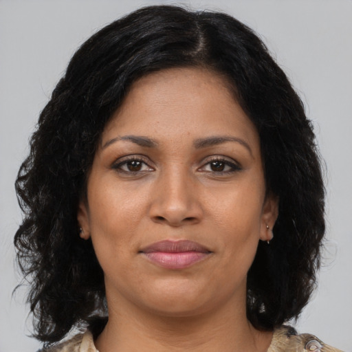 Joyful black young-adult female with medium  brown hair and brown eyes