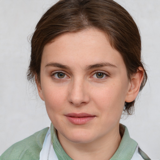 Joyful white young-adult female with medium  brown hair and grey eyes