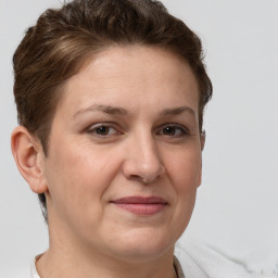 Joyful white adult female with short  brown hair and brown eyes