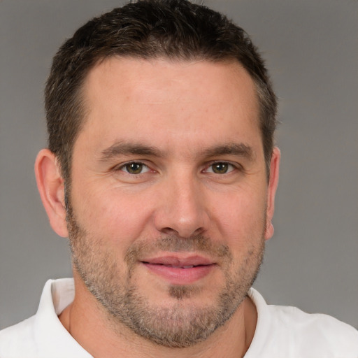 Joyful white adult male with short  brown hair and brown eyes