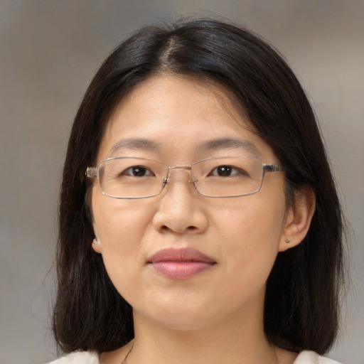 Joyful asian adult female with medium  brown hair and brown eyes