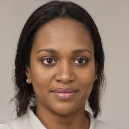 Joyful black young-adult female with medium  brown hair and brown eyes