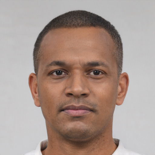 Neutral latino young-adult male with short  brown hair and brown eyes