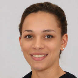 Joyful latino young-adult female with short  brown hair and brown eyes