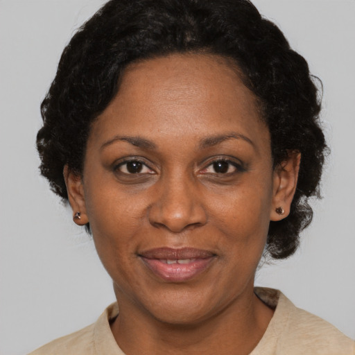 Joyful black adult female with short  black hair and brown eyes
