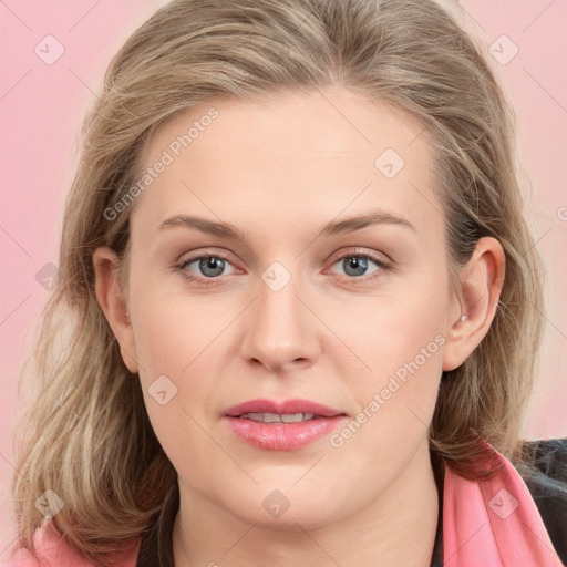 Joyful white young-adult female with long  brown hair and blue eyes