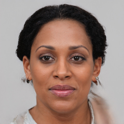 Joyful black adult female with short  brown hair and brown eyes