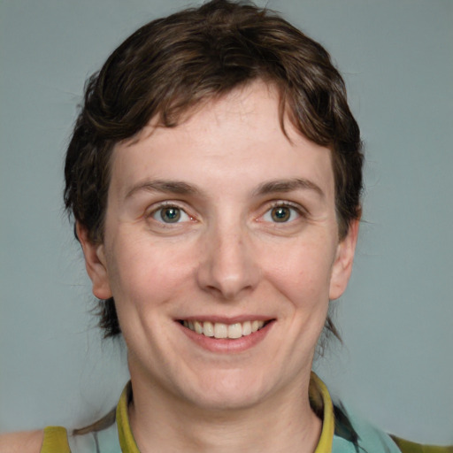 Joyful white young-adult female with medium  brown hair and green eyes