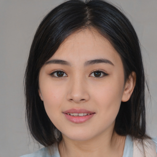 Joyful asian young-adult female with medium  black hair and brown eyes