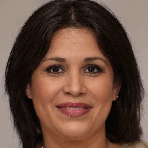 Joyful white adult female with medium  brown hair and brown eyes