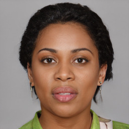 Joyful black young-adult female with short  black hair and brown eyes