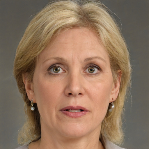 Joyful white adult female with medium  brown hair and green eyes