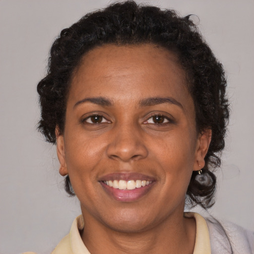 Joyful latino adult female with short  brown hair and brown eyes