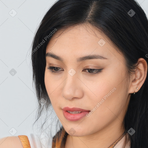 Joyful asian young-adult female with long  brown hair and brown eyes