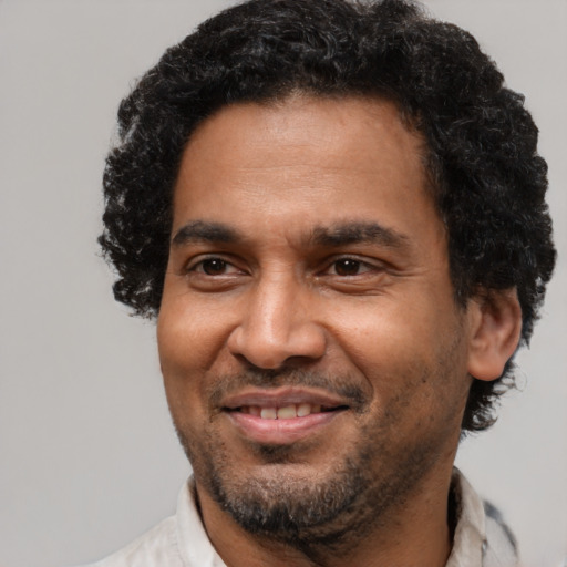 Joyful latino adult male with short  black hair and brown eyes