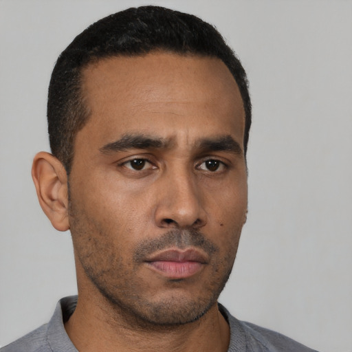 Neutral latino young-adult male with short  black hair and brown eyes