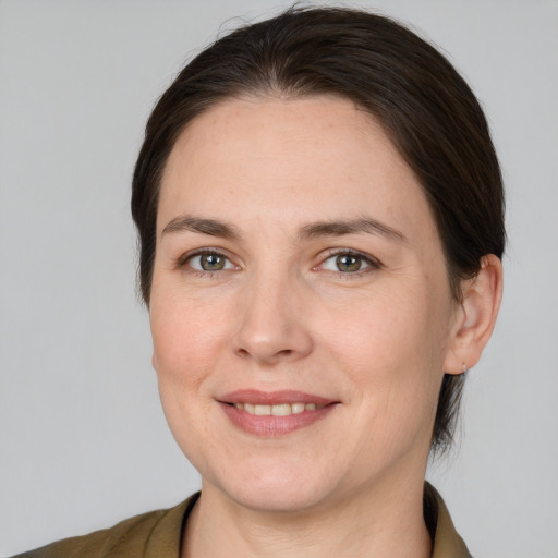 Joyful white adult female with medium  brown hair and brown eyes