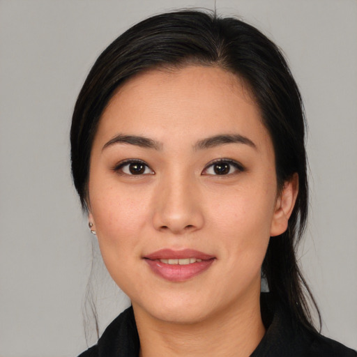 Joyful latino young-adult female with medium  black hair and brown eyes