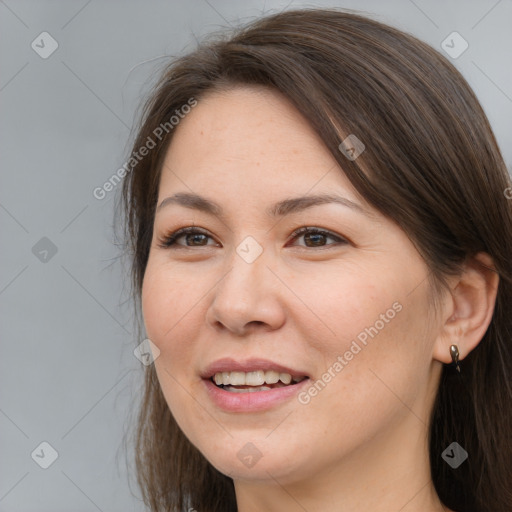 Joyful white young-adult female with long  brown hair and brown eyes