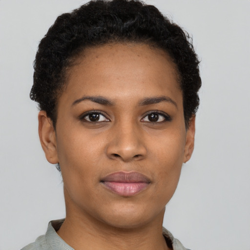 Joyful black young-adult female with short  black hair and brown eyes