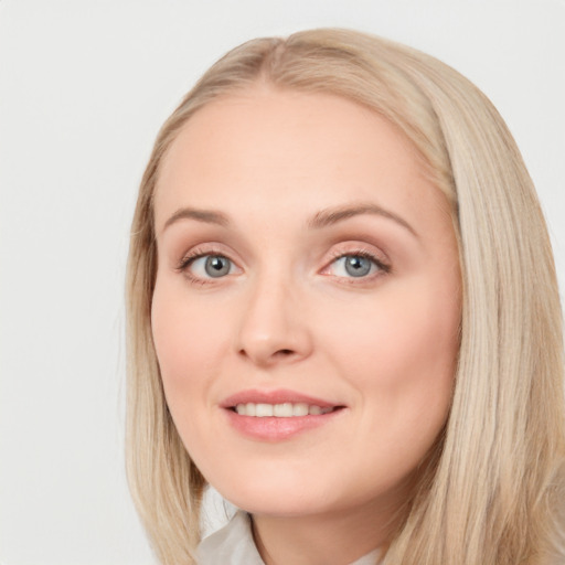 Joyful white young-adult female with long  brown hair and blue eyes