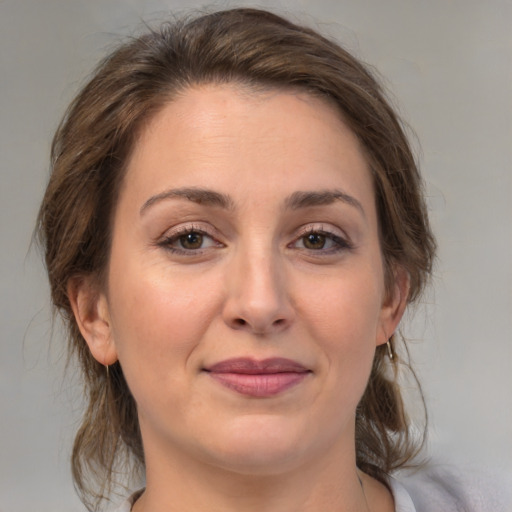 Joyful white young-adult female with medium  brown hair and brown eyes