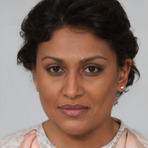 Joyful latino adult female with short  brown hair and brown eyes