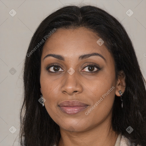 Joyful black young-adult female with long  brown hair and brown eyes