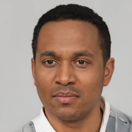 Neutral latino adult male with short  black hair and brown eyes