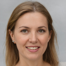 Joyful white adult female with medium  brown hair and grey eyes